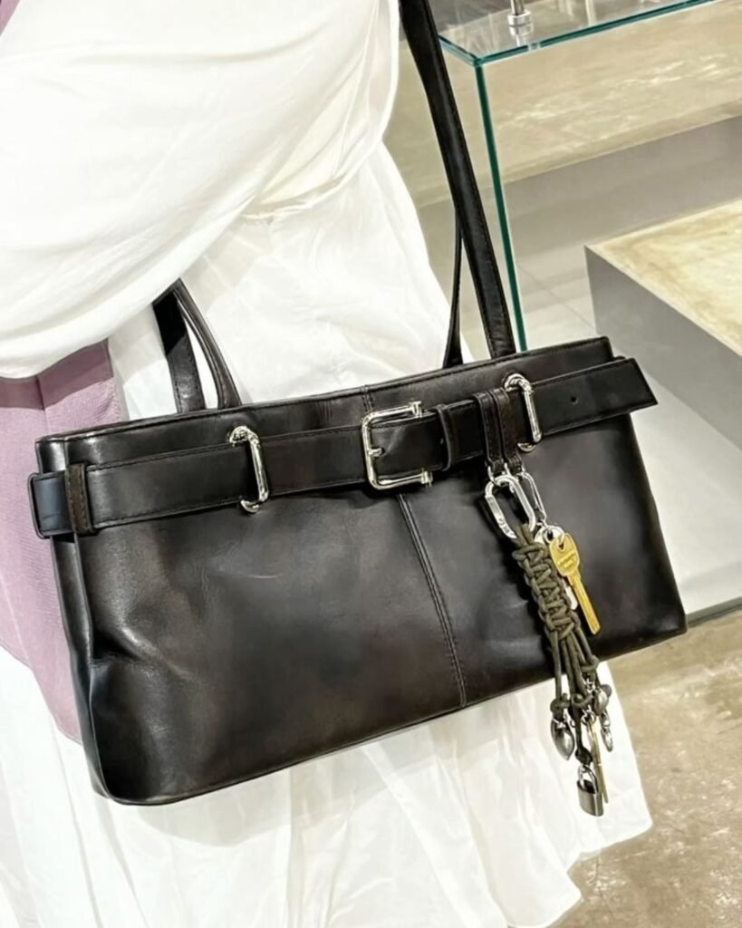 A woman wearing the Osoi brocle bag in black