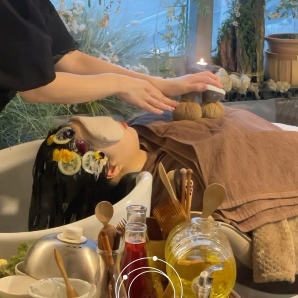 A woman receiving scalp care at a head spa