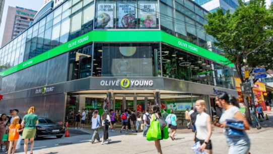 Shoppers walking in front of Olive Young's flagship store