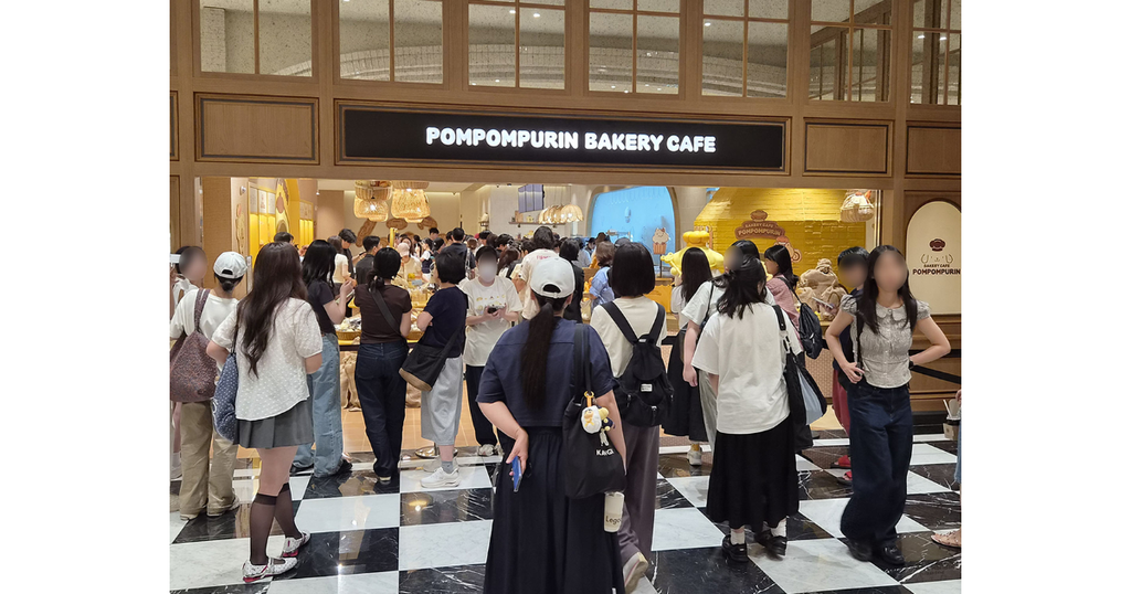 A long line of young consumers queuing outside the Pompompurin Bakery Cafe inside Shinsegae Gangnam.